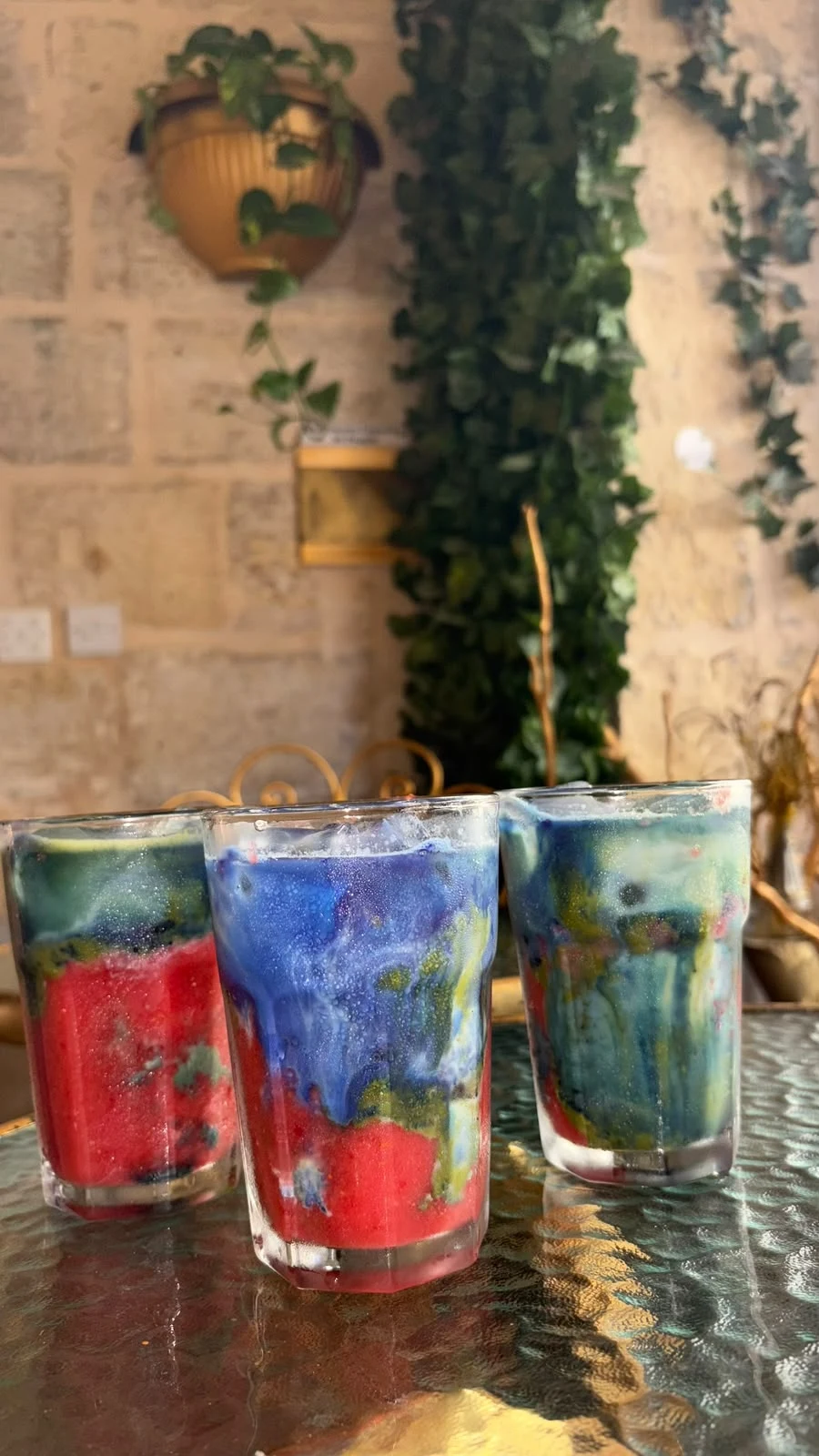 Colourful layered drinks on a glass table
